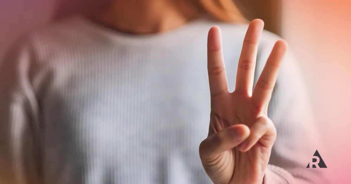 women holding up 3 fingers