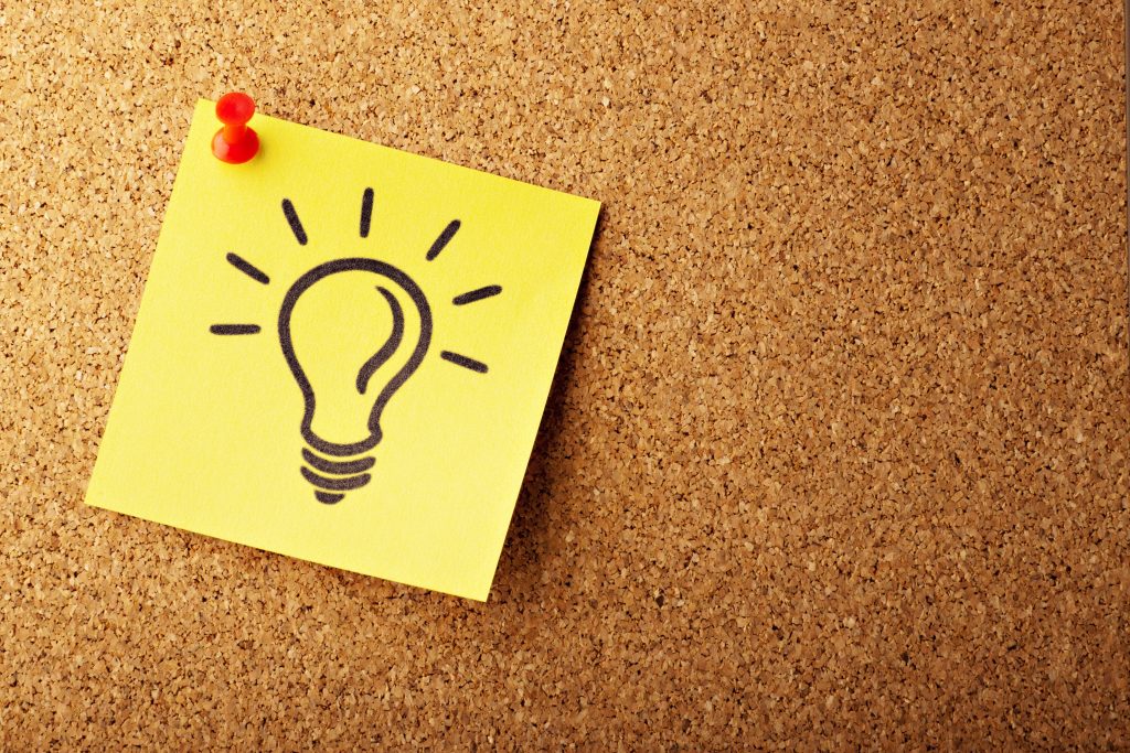 lightbulb on sticky note on board