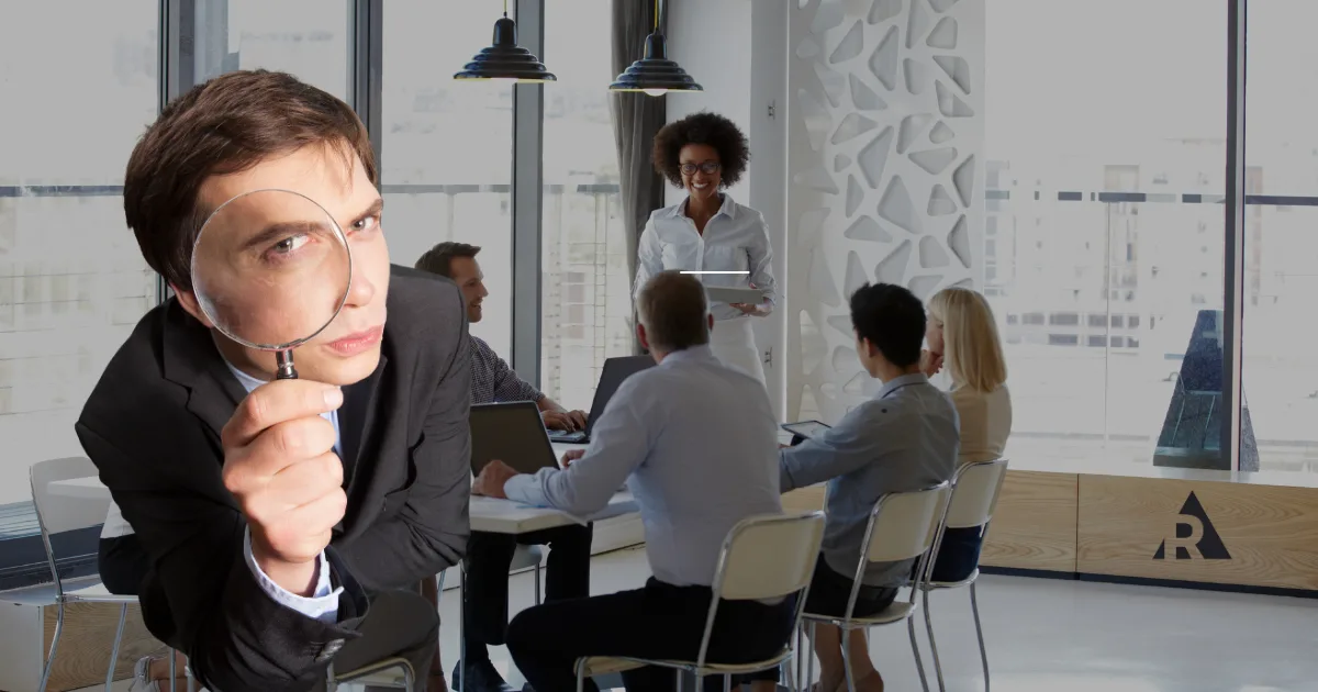 Employee observing a team meeting, representing workplace transparency and open communication.
