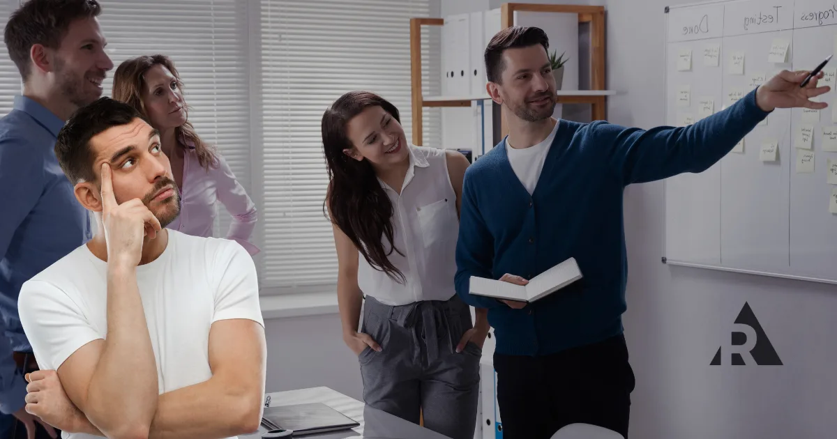 Man wonders how to make Agile last while teammates collaborate around a planning board.