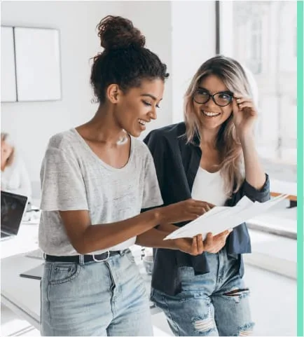 two women reviewing papers scrum training